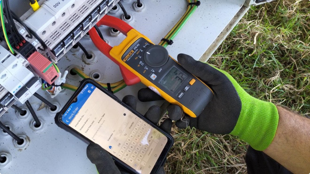 technician logging meter readings in a mobile inspection app after visual inspection